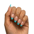 Blue French Tips press-on nails with sheer nude base and turquoise blue French tips in almond or round almond shape, medium length, glossy finish, shown on hand