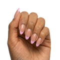 Lilac French Tips press-on nails with sheer nude base and lilac French tips in almond or round almond shape, medium length, glossy finish, shown on hand