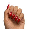 Red press-on nails in cat-eye shimmer style, medium length almond shape, glossy finish, shown on hand 